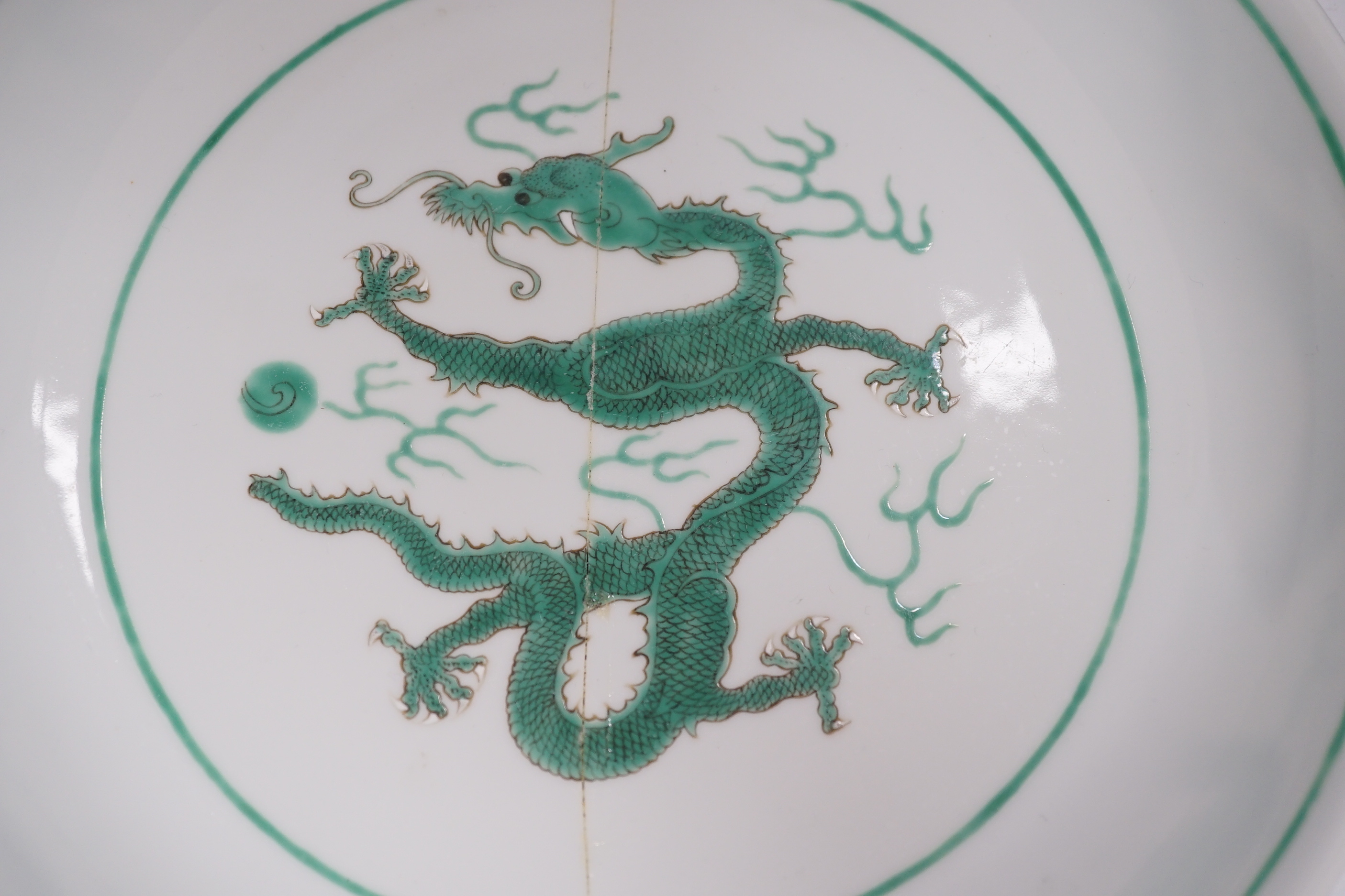 A Chinese green enamelled porcelain ‘dragon’ dish, 24cm in diameter (a.f.)